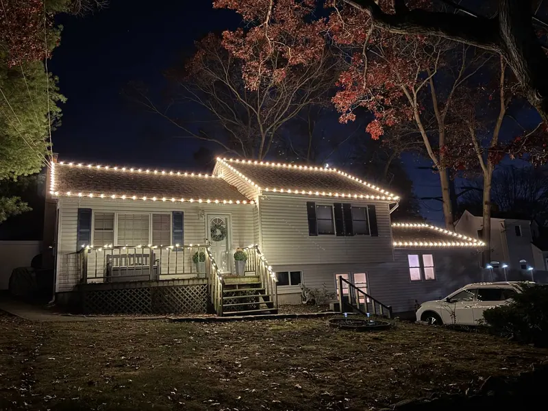 Warm white lighting on a hi-ranch with porch railing